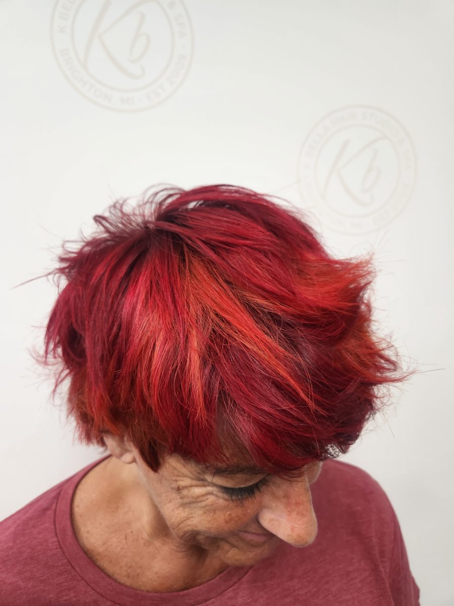 Precision Piecey vibrant retro color and choppy cut with rich custom color by Siobhan Rozinski at K Bella Hair Studio & Spa in Brighton, MI