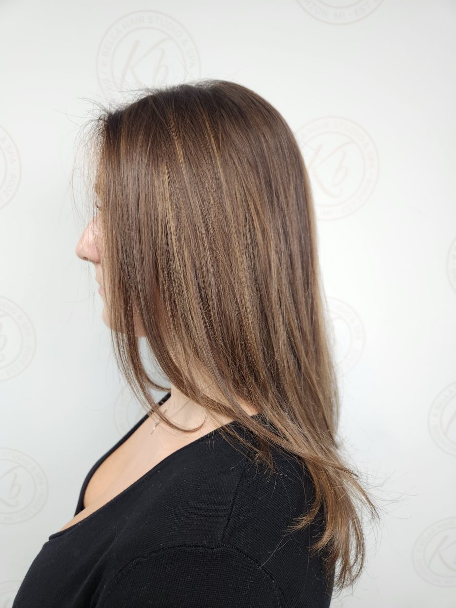 Side profile of long straight hair with balayage highlights from mid-length to ends, by Siobhan Rozinski at K Bella Hair Studio & Spa in Brighton, MI