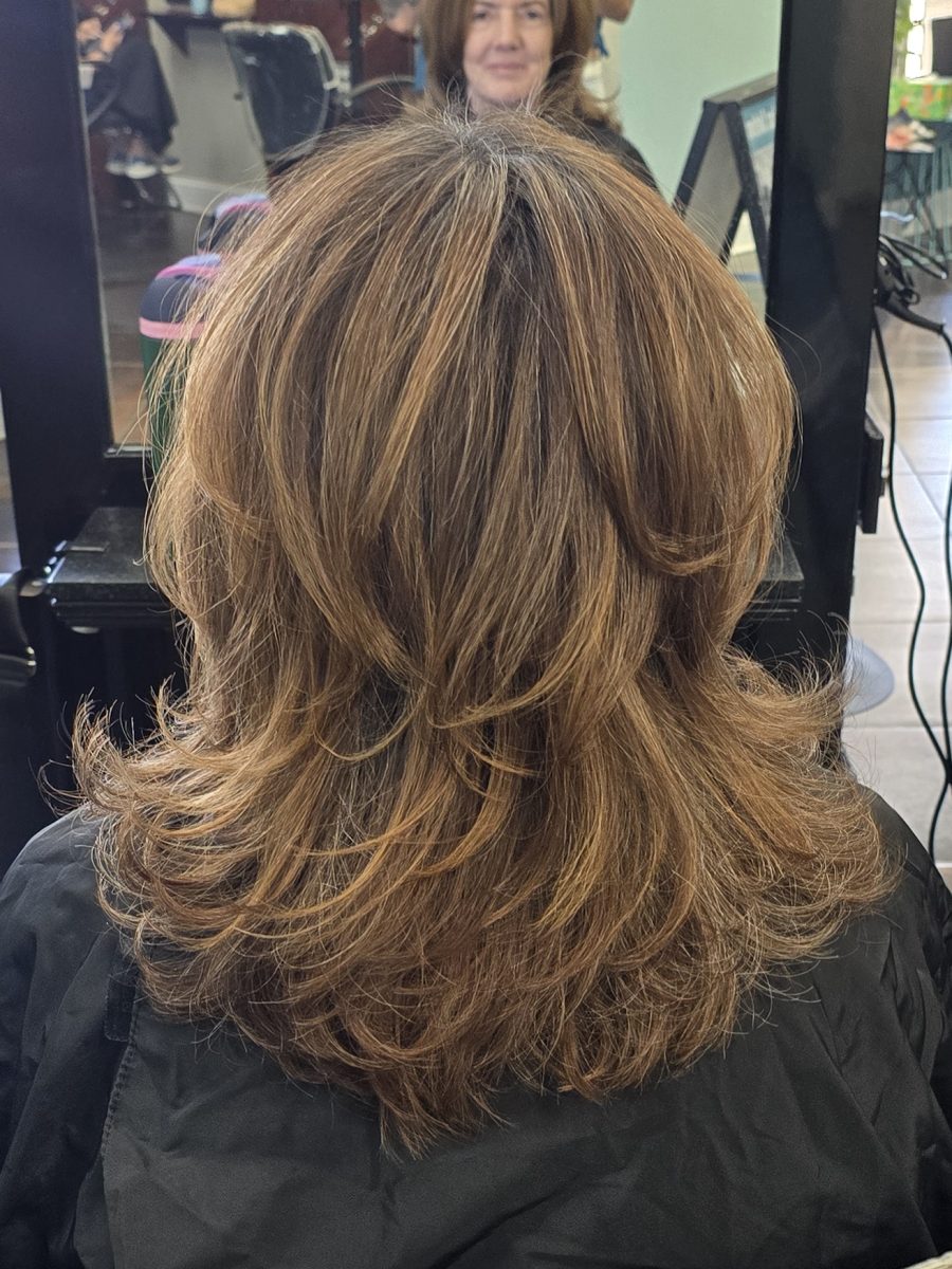 Back view of shoulder-length shag haircut with layered texture and chunky chocolate and caramel highlights, by Kristan Sayers at K Bella Hair Studio & Spa in Brighton, MI