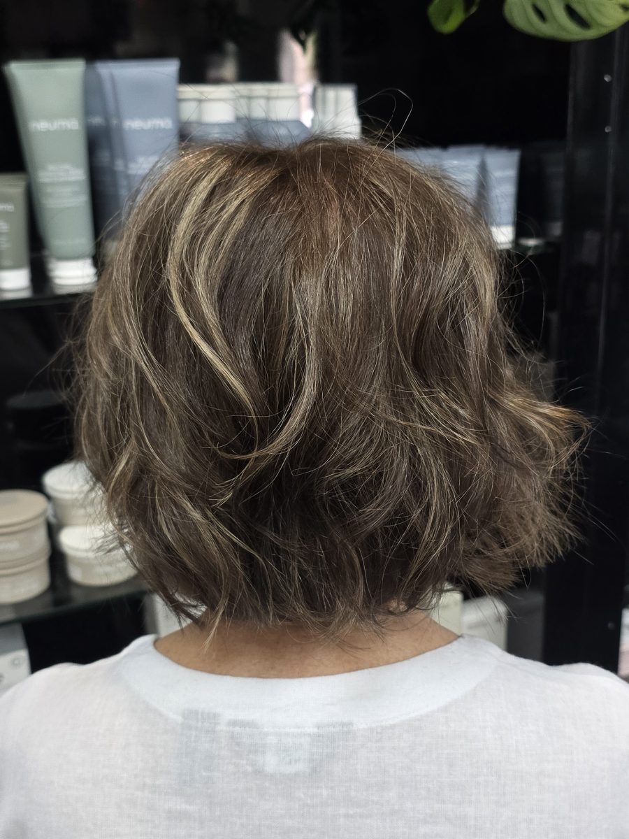 Back view of a short graduated bob with chunky highlights in vanilla blonde and dark golden brown by Kristan Sayers at K Bella Hair Studio & Spa in Brighton, MI