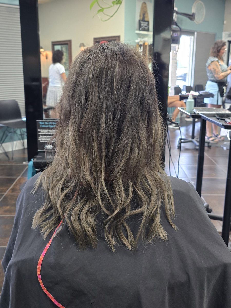 Back view of shoulder-length shag haircut with choppy layers and woven-in extensions for added volume and dimension, by Kristan Sayers at K Bella Hair Studio & Spa in Brighton, MI