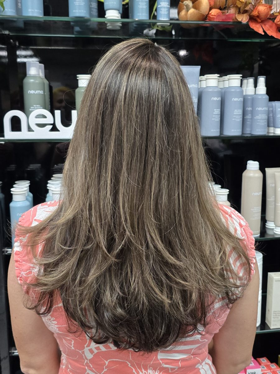 Back view of long layered hair with warm and cool tones blended throughout, by Kristan Sayers at K Bella Hair Studio & Spa in Brighton, MI