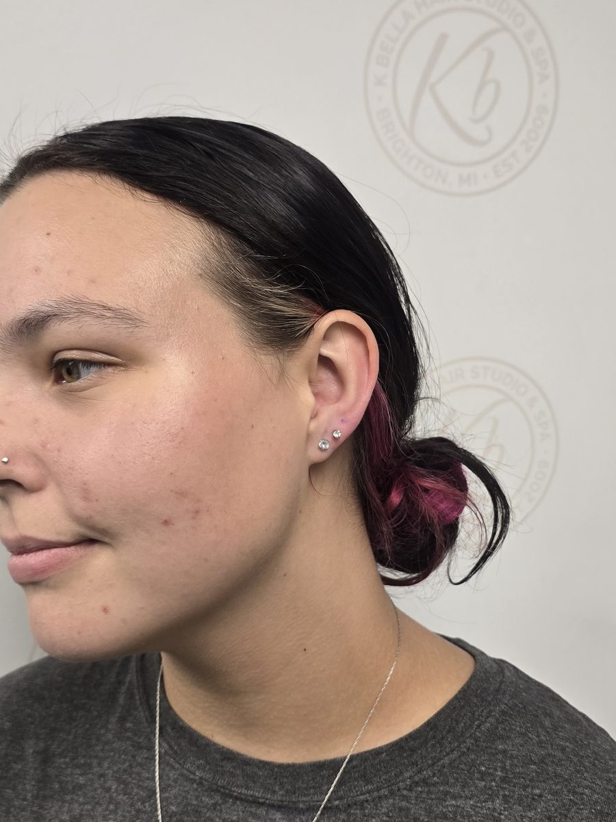 Close-up side profile showing newly pierced second lobe and cartilage with jewelry in place by Paige Spence at K Bella Hair Studio & Spa in Brighton, MI