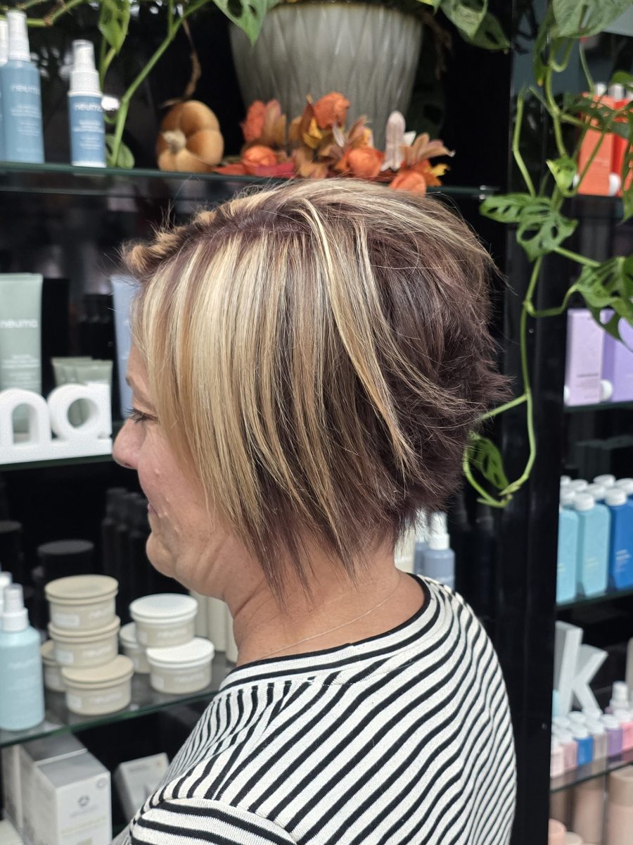 Side view of a short choppy haircut with chunky blonde and violet highlights, styled close to the head by Kristan Sayers at K Bella Hair Studio & Spa in Brighton, MI