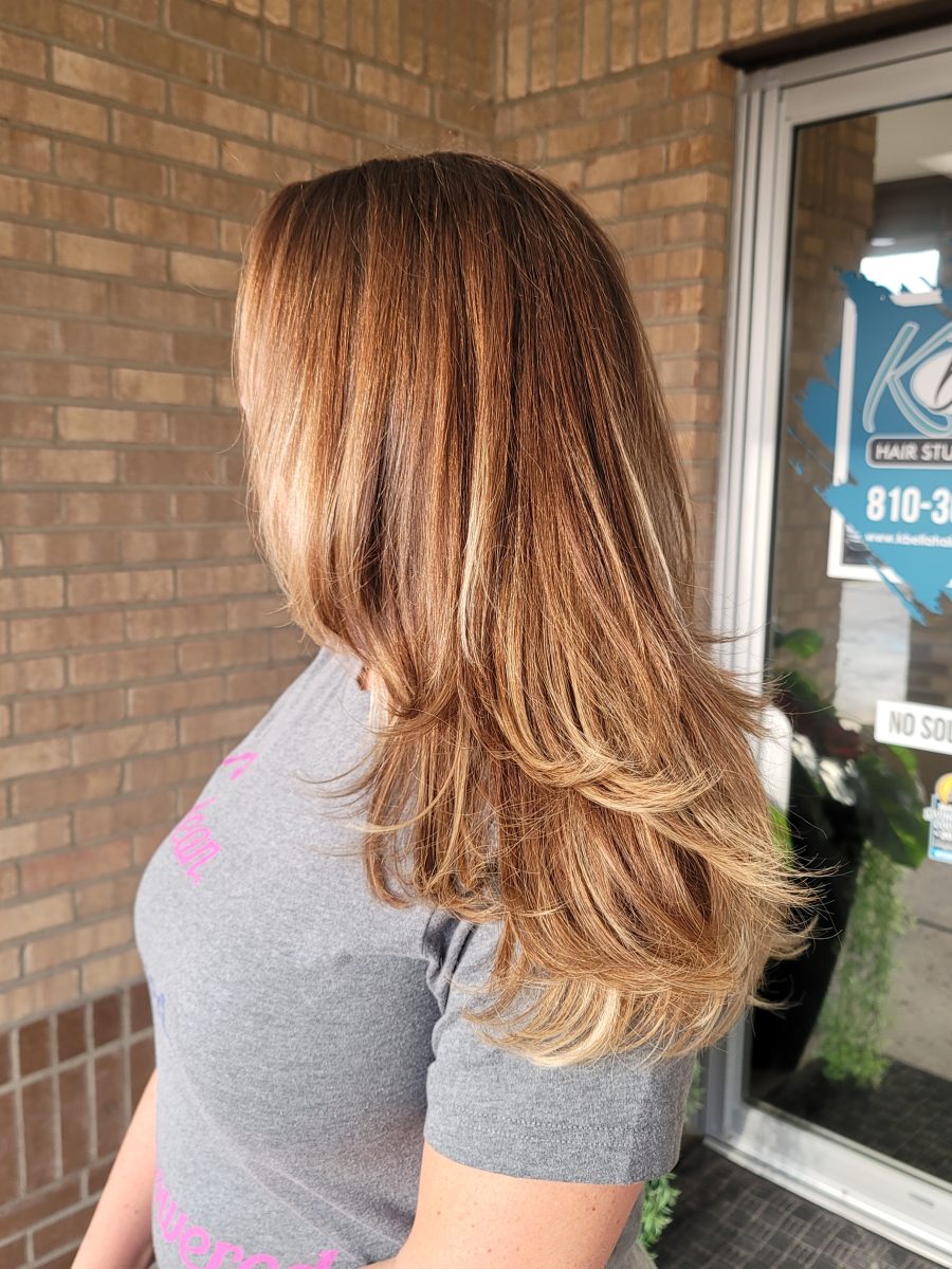 Back view of long hair with balayage color work by Kristan Sayers at K Bella Hair Studio & Spa in Brighton, MI