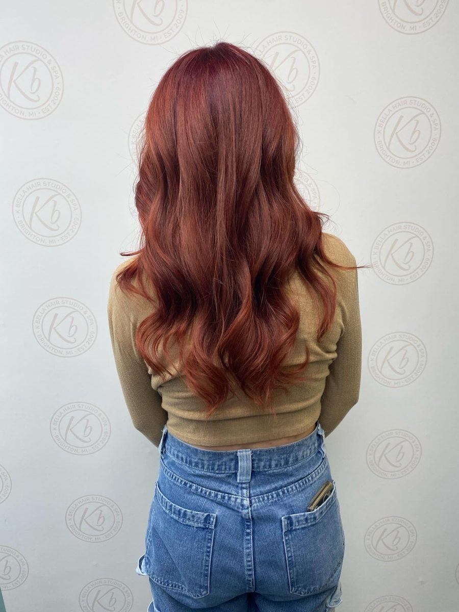Back view of long layered copper red hair showing texture and color depth by Abbey French at K Bella Hair Studio & Spa in Brighton, MI
