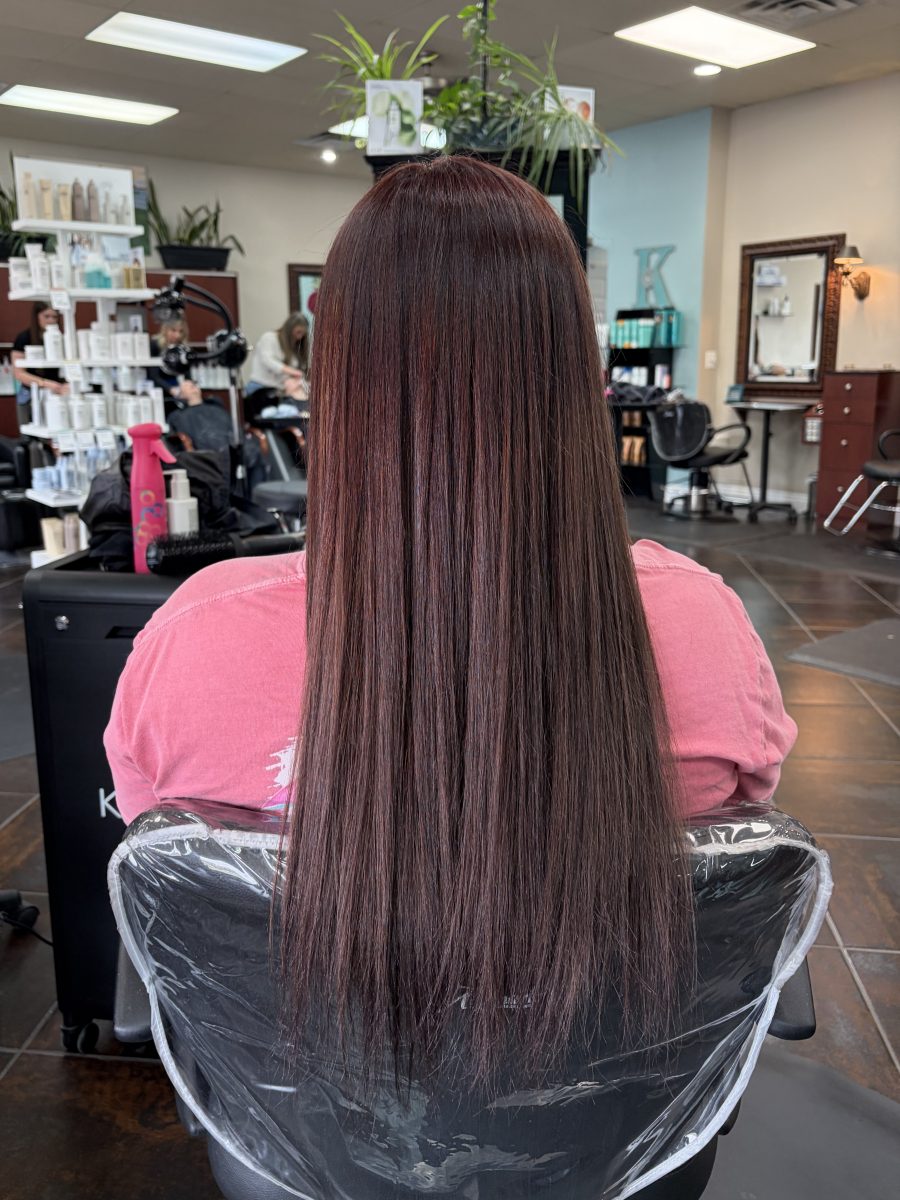 Custom All over color with darkened root and red and violet pulled through the lengths with fresh root touch-up by Paige Spence at K Bella Hair Studio in Brighton, MI