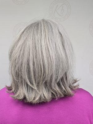 Back view of a silver bob with layered haircut, showing textured ends and movement, by Kristan Sayers at K Bella Hair Studio & Spa in Brighton, MI