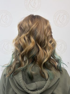 Dimensional highlights and lowlights accented with vivid color by Abbey French at K Bella Hair Studio in Brighton, MI