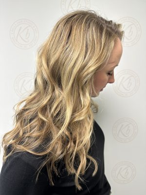 Seamless hair extensions adding length and volume by Liberty Greenwood at K Bella Hair Studio in Brighton, MI