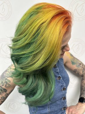 Vivid fashion hair color with rich custom color by Liberty Greenwood at K Bella Hair Studio in Brighton, MI