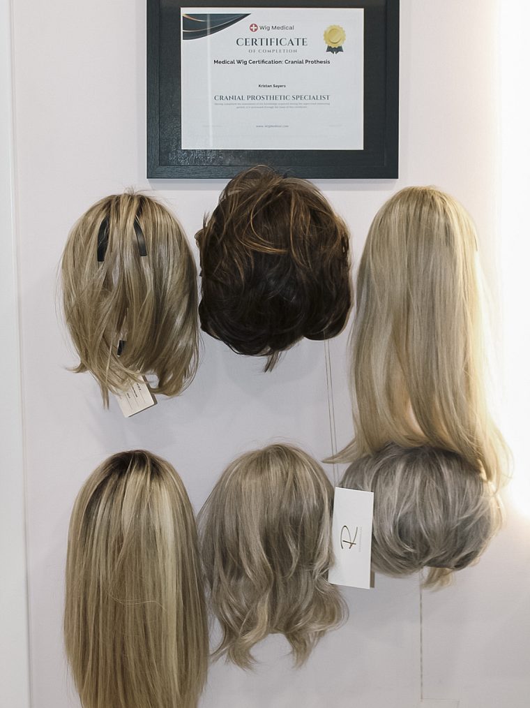 Wigs and toppers on display beneath our Wig Medical cranial prosthesis certification